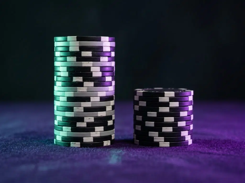Two stacks of AUD chips of different height under mint and violet light, WinSpirit welcome package