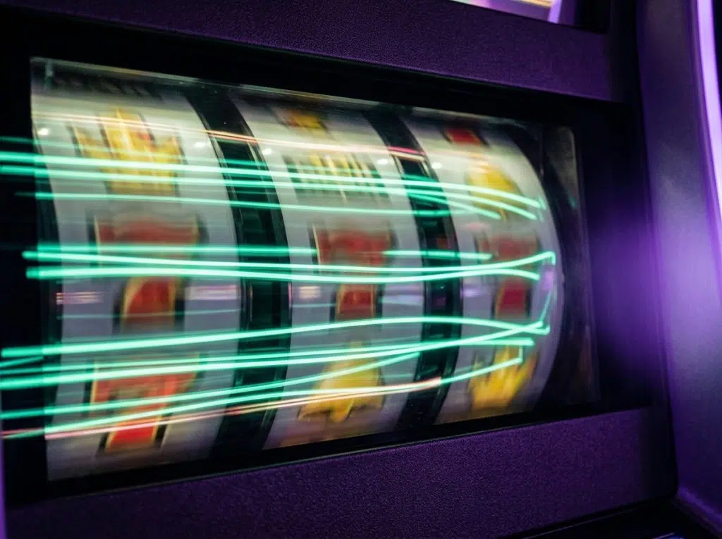 Pokie reels in motion behind mint light streaks, WinSpirit free spins